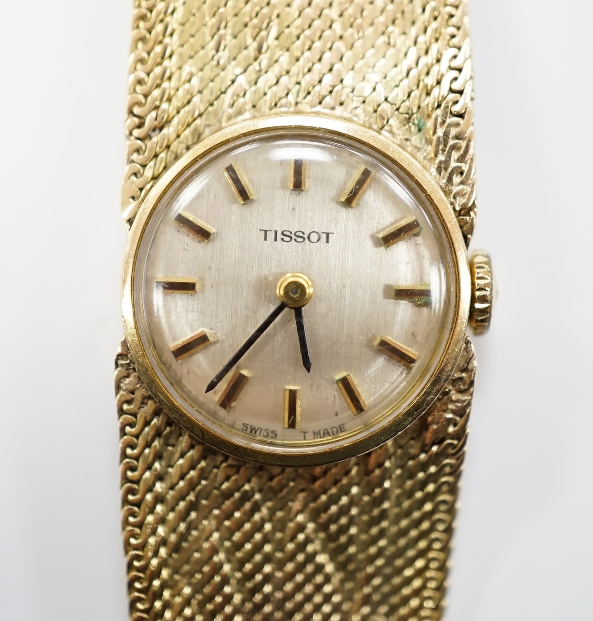 A lady's 9ct gold Tissot manual wind wrist watch, on a 9ct bracelet, 16cm